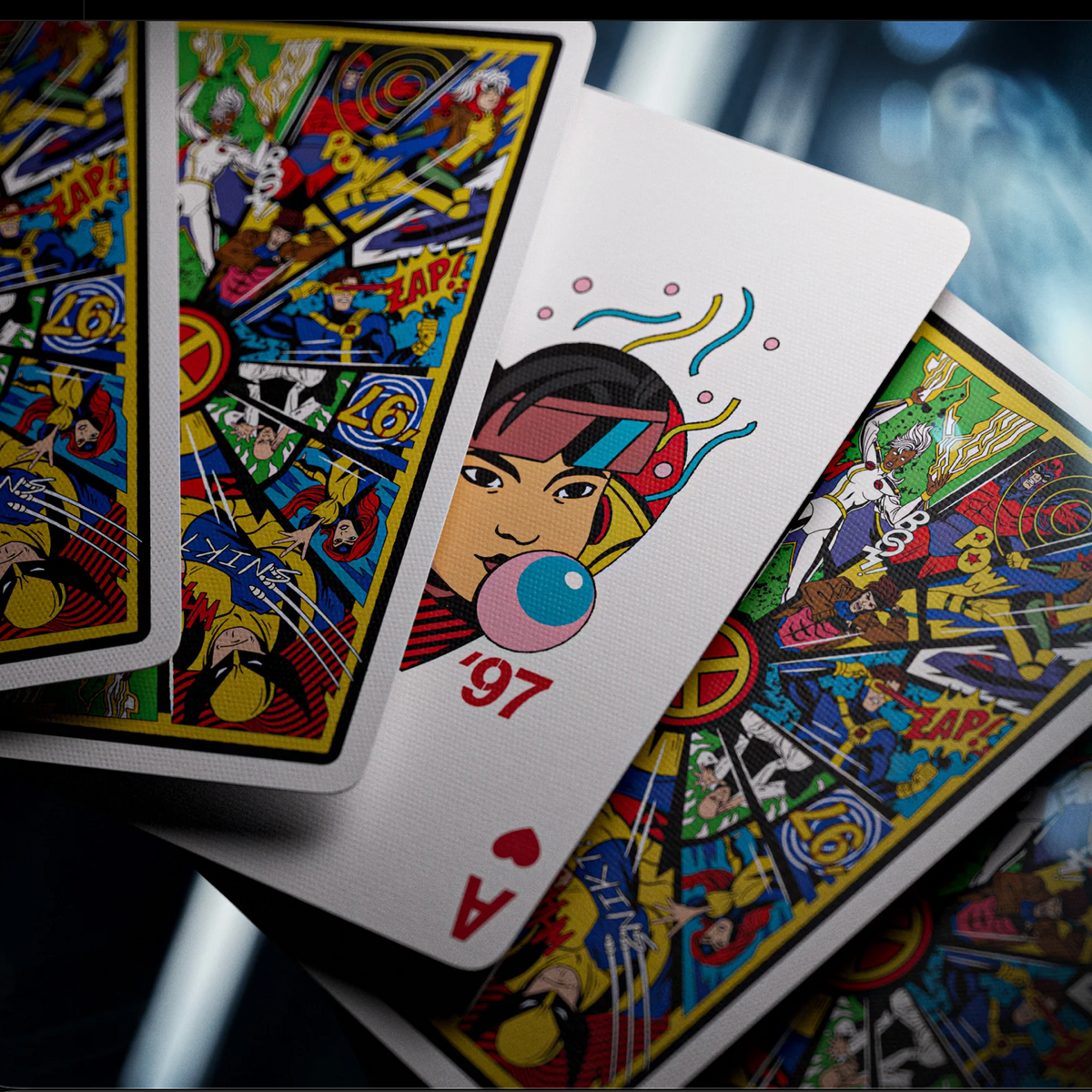 Theory11 X-Men Ace of Hearts featuring Jubilee blowing a bubble, with a '97 reference and overlapping card backs.