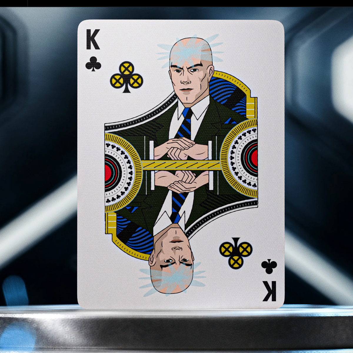 Professor X as the King of Clubs in theory11 X-Men Playing Cards, with folded hands and custom X-emblem club symbols.