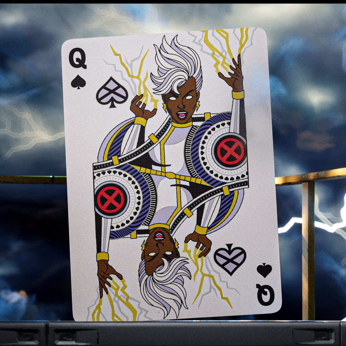 Storm as the Queen of Spades in theory11 X-Men Playing Cards, with white hair, a white costume, and lightning artwork.