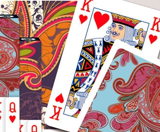 Playing cards with colorful designs and red hearts on a white background