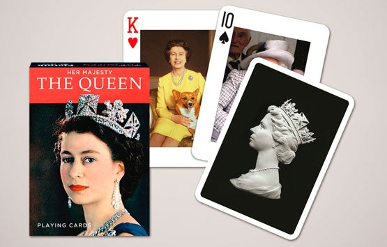 Playing cards featuring images of a queen and a dog on a gray background