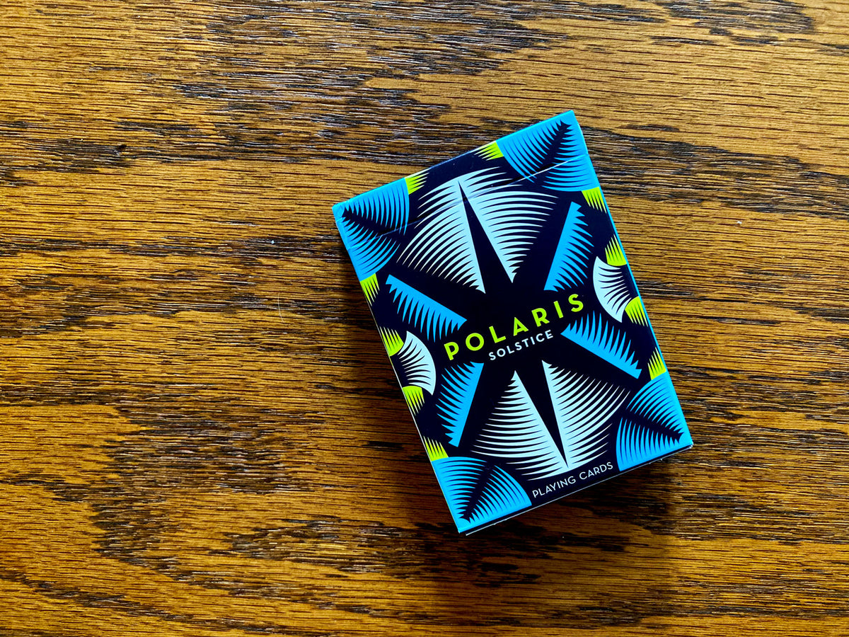 Polaris Winter Solstice Playing Cards tuck box photographed on a wooden tabletop